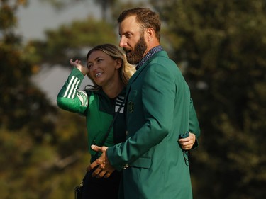 Dustin Johnson of the U.S. celebrates with his green jacket and partner Paulina Gretzky after winning The Masters.