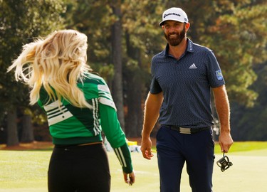 Dustin Johnson of the U.S. celebrates with partner Paulina Gretzky on the 18th green after winning The Masters.