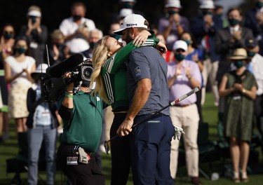Dustin Johnson of the U.S. celebrates with his partner Paulina Gretzky on the 18th green after winning The Masters