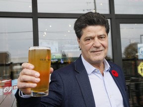Unifor National President Jerry Dias raises a glass at the Portly Piper Pub in Oshawa after GM announced they will reopen the Oshawa assembly plant on Thursday November 5, 2020.
