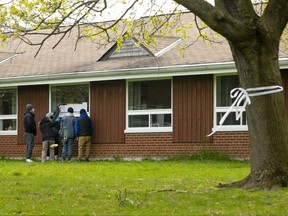 A resident at Orchard Villa Care home in Pickering, receives a Mother's Day visit from her family, on Sunday, May 10, 2020. Residents of a long-term care home hard hit by the COVID-19 pandemic were crammed into overstuffed rooms and denied access to life-saving treatment because the facility was short on both staff and equipment, their families told Ontario's commission on the matter.