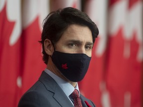 Prime Minister Justin Trudeau listens to a Minister speak via video conference during a news conference in Ottawa,  Tuesday November 10, 2020. THE CANADIAN PRESS/Adrian Wyld