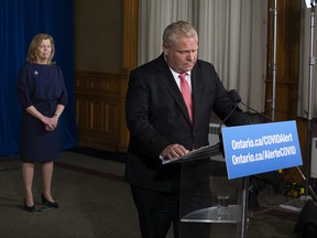 Premier Doug Ford and Health Minister Christine Elliott attend a news conference at the legislature in Toronto on Wednesday, November 25, 2020.