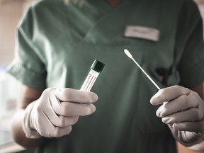 A nurse holds a swab for the coronavirus test.