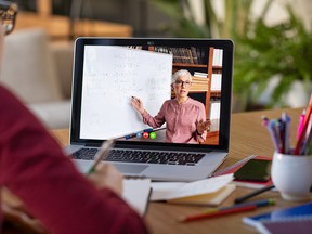 Student watching lesson online and studying from home.