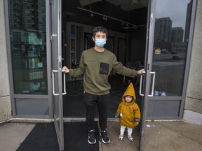 Hao Gao, owner of shut down Rong Style salon, and his daughter Aria, on Finch Ave. W., near Yonge St. in Toronto, Ont. on Thursday, Nov. 26, 2020.
