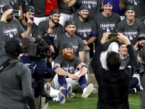 Dodgers’ Justin Turner (centre) poses for a photo with teammates after Los Angeles defeated the Tampa Bay Rays in Game 6 
to win the World Series on Oct. 27 in Arlington, Texas. Turner had a positive COVID-19 test discovered mid-game.