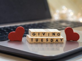 GIVING TUESDAY letter blocks concept on laptop keyboard