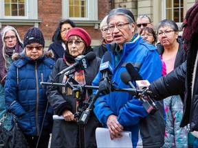 St. Anne's residential school survivor Edmund Metatawabin speaks to media with fellow survivor Evelyn Korkmaz and Deputy Grand Chief Rebecca outside the Ontario Super Court of Justice in Toronto.