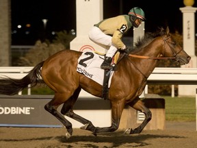 Jockey Patrick Husbands guides Ride a Comet to victory in the $175,000 Kennedy Road stakes at Woodbine on Nov. 21, 2020.