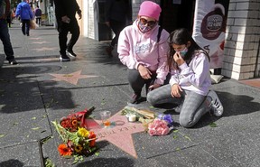 Lisa Andrade, 47, and her daughter Bridgete, 9, place flowers on the star of TV host Alex Trebek, on the Hollywood Walk of Fame in Los Angeles on Monday. REUTERS