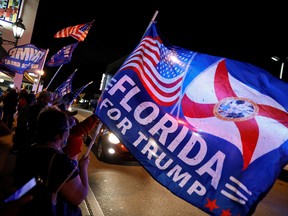 Supporters of President Donald Trump wave flags during the U.S. presidential election, outside Versailles Restaurant at Little Havana neighborhood in Miami, Florida, November 3, 2020.