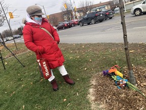 Erlinda Colos stands near a little memorial that is starting to grow for an innocent 12-year-old that was shot and killed during a gang shootout on Saturday in the parking lot of a Jane St. and Stong Crt. apartment on Friday November 13, 2020. Jack Boland/Toronto Sun/Postmedia Network