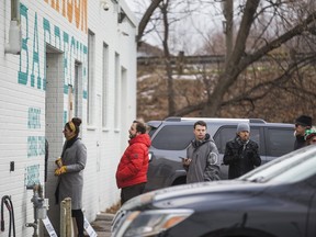People line up for Adamson Barbecue in Toronto on Tuesday, November 24, 2020.  The Etobicoke location was open for  dine-in service, despite the latest 28-day pandemic close order.
