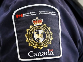 A Canada Border Services Agency (CBSA) patch is seen on an officer in Calgary, Alta., Thursday, Aug. 1, 2019.