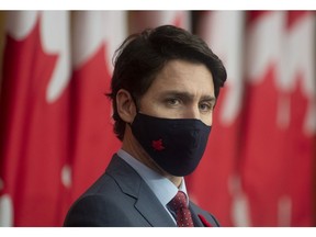 Prime Minister Justin Trudeau listens to a Minister speak via video conference during a news conference in Ottawa, Tuesday November 10, 2020.