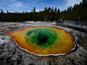 Tourists view the Morning Glory hot spring in the Upper Geyser Basin of Yellowstone National Park in Wyoming, on May 14, 2016.
