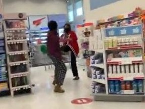 A woman nearly strikes and kicks a Shoppers Drug Mart employee in Scarborough in a video posted online.