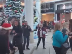 Maskless demonstrators dance at a mall in Rosemere, Quebec.