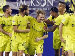 Nashville SC midfielder Dax McCarty (third from left) is congratulated after scoring against Inter Miami during MLS play-in action on Friday in Nashville. The first-year team will take on Toronto FC in a first-round playoff series starting Tuesday.