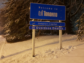 A sign has been added to the city limits sign on Burhamthorpe Rd. E., near Mill Rd. to draw attention to Toronto’s overdose crisis.