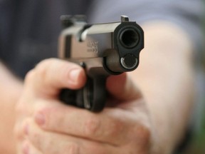 File photo of a man holding a Colt .45 semi-automatic pistol.