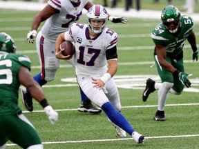 Quarterback Josh Allen #17 of the Buffalo Bills runs with the ball against the New York Jets in the fourth quarter of the game at MetLife Stadium on October 25, 2020 in East Rutherford, New Jersey.