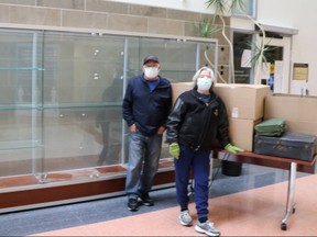 Lynn Philip Hodgson, left, removes the Camp X display from Durham Regional Headquarters after staff complaints over 'offensive' artifacts. 

Camp X was a top-secret spy school operated in Whitby during the Second World War.