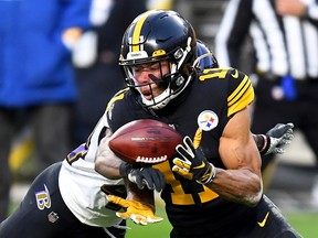 Marlon Humphrey  of the Baltimore Ravens breaks up a pass intended for Chase Claypool  of the Pittsburgh Steelers during the first half of the game at Heinz Field.