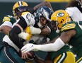 Carson Wentz #11 of the Philadelphia Eagles is sacked by Kingsley Keke #96 and Preston Smith #91 of the Green Bay Packers on Sunday. Wentz was benched in the Packers' win.