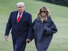 U.S. President Donald Trump and First Lady Melania Trump walk on the South Lawn while returning to the White House on Dec. 31, 2020 in Washington, D.C.