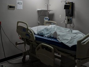 A deceased patient in a body bag is shown on a bed in the COVID-19 intensive care unit (ICU) at the United Memorial Medical Center on November 29, 2020 in Houston, Texas