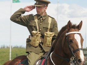In this June 2010 photo, a soldier with Lord Strathcona's Horse (Royal Canadians) salutes as he rides past a senior officer while wearing in a 1940s uniform in Edmonton.