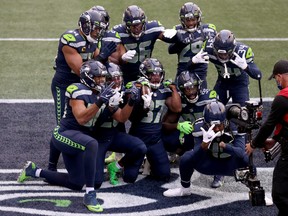 Quandre Diggs (#37) of the Seattle Seahawks and his teammates celebrate his interception against the Los Angeles Rams on Sunday.
