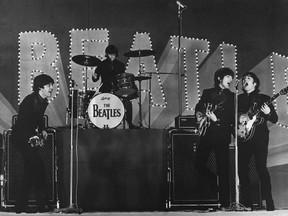 This photo -- taken on June 30, 1966 -- shows The Beatles, (L to R) Paul McCartney, Ringo Starr, George Harrison and John Lennon, performing during their concert at the Budokan in Tokyo.