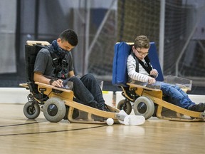 Alex Morrison, 14 (left), and Zach Rayment, 11, are pictured on Volt hockey carts at Variety Village in Toronto on Nov. 20, 2020.