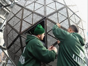 File photo: Technicians install tiles in the Times Square New Year's Eve Waterford Crystal Ball during the Waterford Crystal Installation for Times Square New Year's Eve 2017 at One Times Square on December 27, 2016 in New York City.