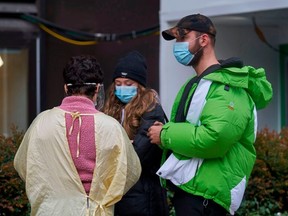 A nurse talks with people in line at a Covid-19 testing center at Mount Sinai Hospital in Toronto, Ontario on Nov. 23, 2020.