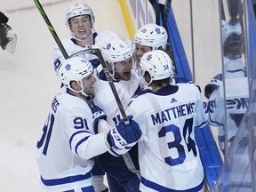 Toronto Maple Leafs forward Zach Hyman (11) celebrates with forward William Nylander (88) and forward John Tavares (91) and forward Auston Matthews (34) and forward Mitchell Marner (16) after scoring a game tying goal against the Columbus Blue Jackets in game four of the Eastern Conference qualifications at Scotiabank Arena.