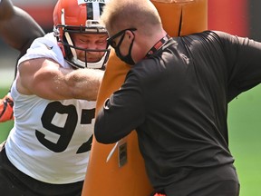 Cleveland Browns defensive end Porter Gustin, left, runs a drill during training camp at the Cleveland Browns training facility in Berea, Ohio, August 14, 2020.