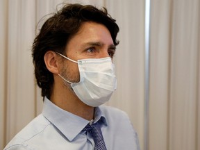Prime Minister Justin Trudeau talks to staff after seeing where the first COVID-19 vaccinations were given at the Civic Hospital in Ottawa on Dec. 15, 2020. REUTERS