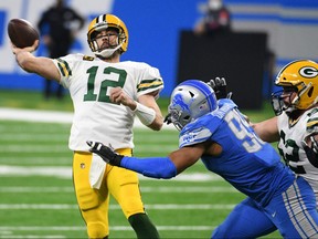 Green Bay Packers quarterback Aaron Rodgers (12) drops back to pass during the third quarter against the Detroit Lions at Ford Field. 
426888