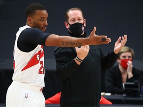 Raptors head coach Nick Nurse talks with guard Norman Powell. The Raptors begin their season Wednesday night against the Pelicans.