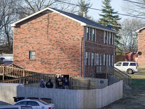 Law enforcement officers gather to investigate information arising the day after a downtown Nashville explosion, outside a duplex house in Antioch, Tenn. Dec. 26, 2020.