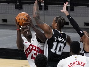 Toronto Raptors forward Pascal Siakam (43) shoots over San Antonio Spurs guard DeMar DeRozan on Saturday night.