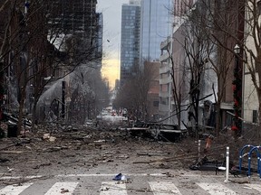 In this photo from the Twitter page of the Nashville Fire Department, damage is seen on a street after an explosion in Nashville, Tenn., on Dec. 25, 2020.