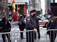 Police officers close the street with fences before the New Year's Eve celebration in Times Square New York on Dec. 31, 2020.