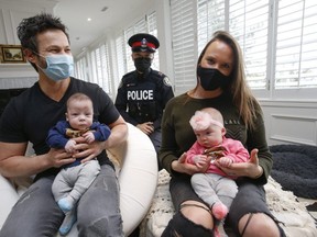 Rob Scheinberg and his wife Danielle at their home in King City, Ont. with five-month old Liam and his twin sister Elise.  Toronto Police Const. Ivan Yeung, at back, came to Rob and his son's aid on Nov. 18 after Liam stopped breathing, performing life-saving CPR on the infant who was turning blue from lack of oxygen.
