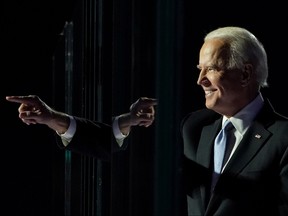 Democratic 2020 U.S. presidential nominee Joe Biden points a finger at his election rally, after news media announced that Biden has won the 2020 U.S. presidential election, in Wilmington, Delaware, U.S., Nov. 7, 2020.
