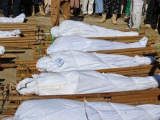 The bodies of 43 farm workers are seen during a funeral in Zabarmari, Nigeria, on November 29, 2020 after they were killed by Boko Haram fighters. The victims were labourers from Sokoto state in northwest Nigeria, roughly 1,000 kilometres (600 miles) away, who had travelled to the northeast to find work. (Photo by Audu Marte / AFP) (Photo by AUDU MARTE/AFP via Getty Images)